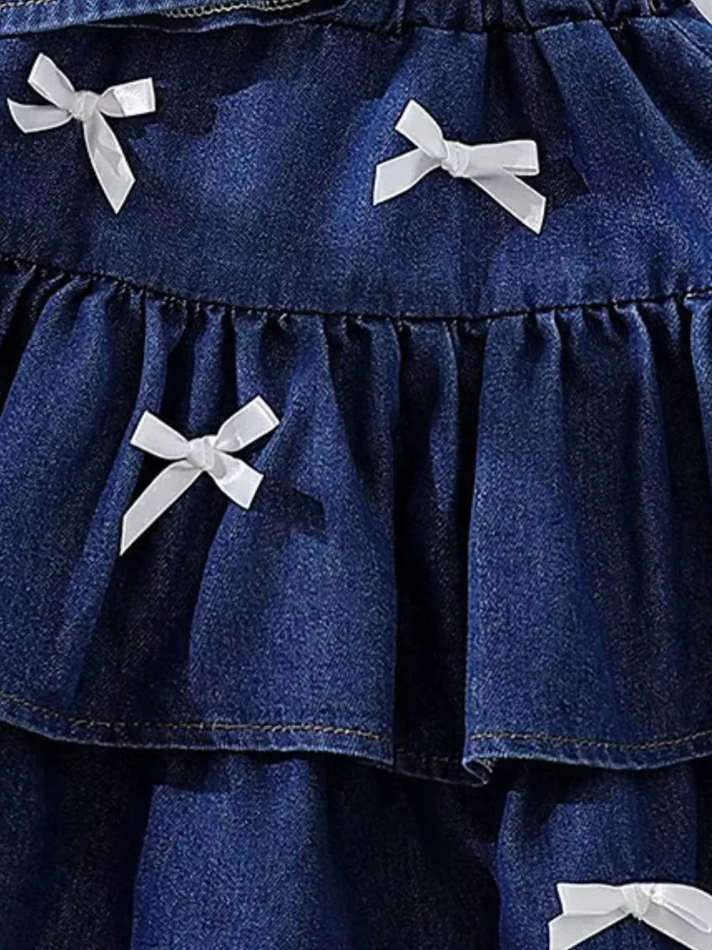 Dark navy denim halter set with white bow accents and ruffled tiers.