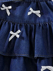 Dark navy denim halter set with white bow accents and ruffled tiers.
