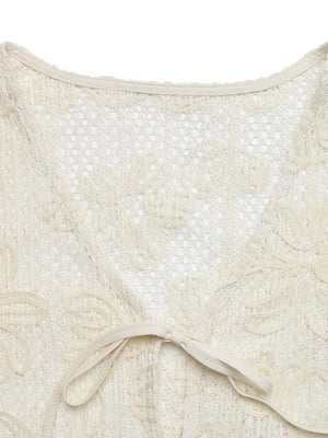 Apricot lace tie-front undershirt with floral cutouts and a V-neck.