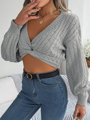 Dark gray acrylic cable knit cropped sweater with V-neck and twist front detail