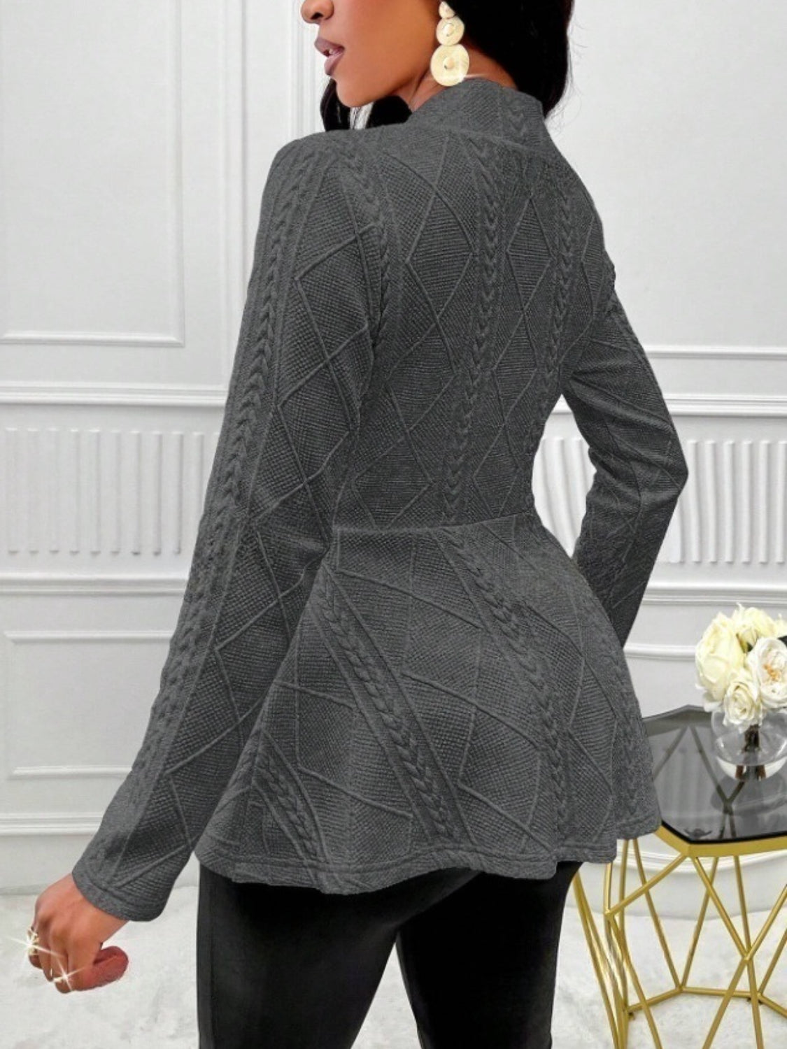 Gray textured knit peplum blazer with diamond and cable knit patterns.