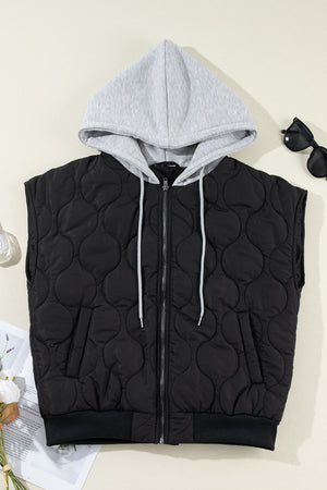 Black quilted sleeveless jacket with grey hooded neckline and white drawstrings.