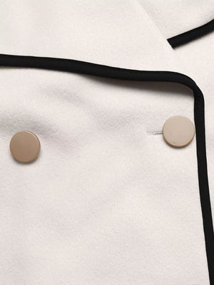 Beige bolero jacket with black contrast trim and button detail.