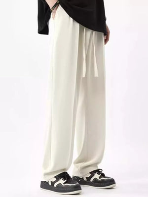 Men's ivory wide leg sweatpants with drawstring waist and pockets.