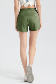 Layered performance running shorts in matcha green with elastic waistband and curved hem.