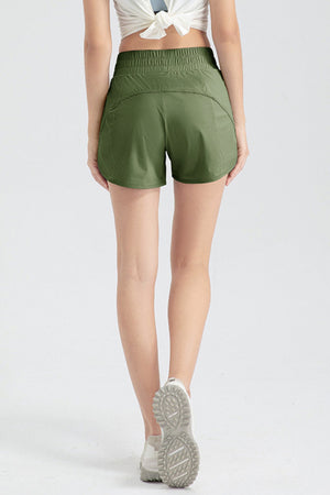 Layered performance running shorts in matcha green with elastic waistband and curved hem.