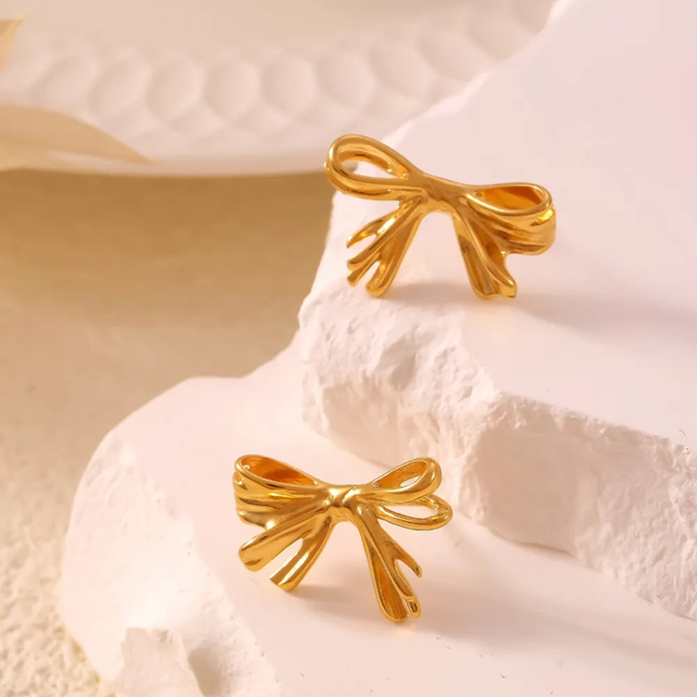 Golden bow stud earrings with a chic design.