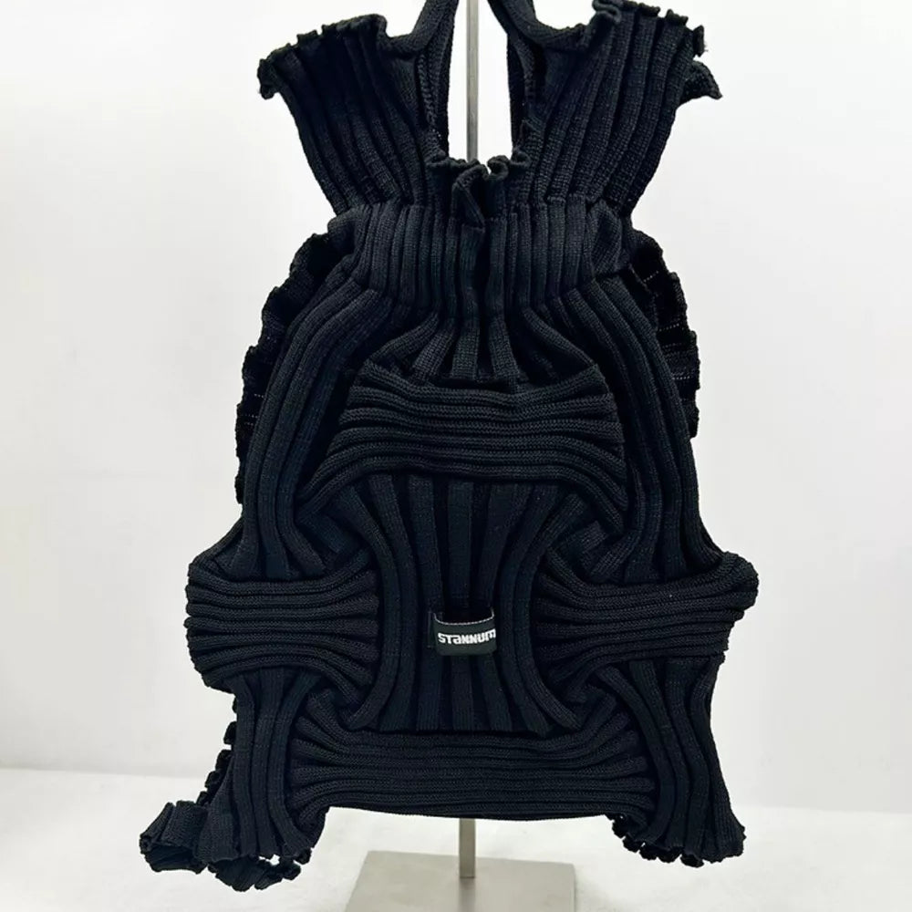 Black textured knit medium backpack with ruffled edges and woven detail.