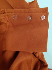 Ochre polyester two-piece set with pocket detail and clear button cuffs