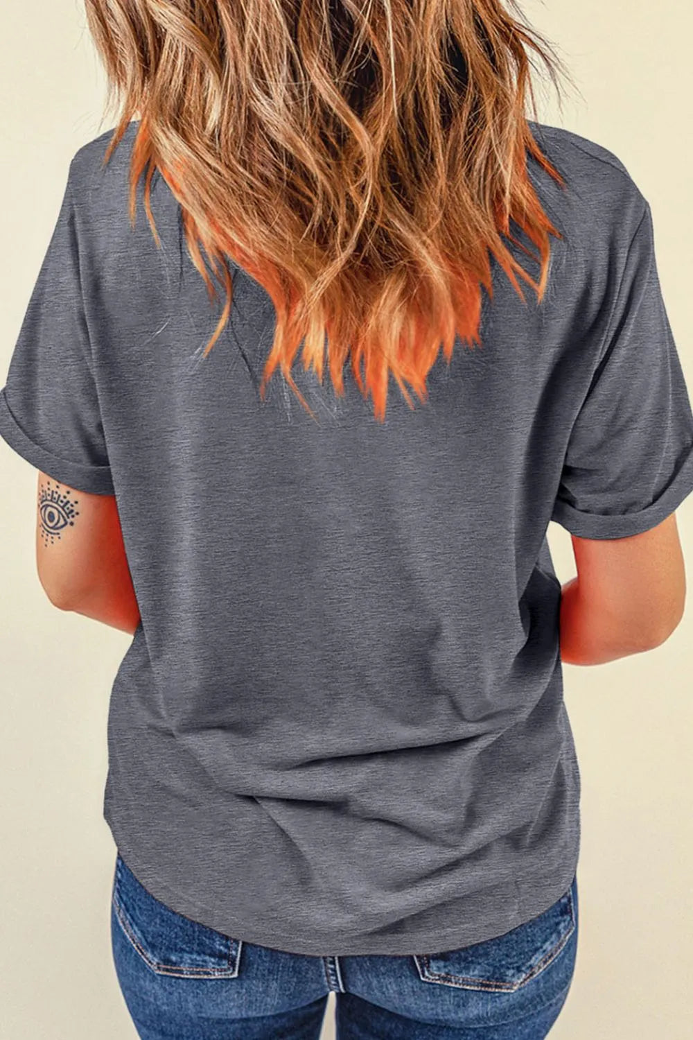Gray casual t-shirt with rolled short sleeves and a western tattoo graphic on the arm.