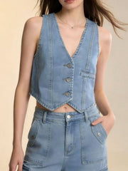 Light blue denim vest with button front and V-neck, cropped length, paired with matching jeans.