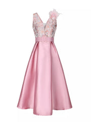 Pink midi dress with floral appliqué bodice, V-neck, belted waist, and a-line skirt.