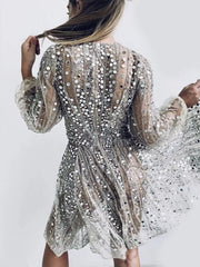 Silver sequin mini dress with balloon sleeves and a-line cut, featuring a sheer overlay.
