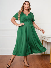 Emerald green polyester midi dress with a twist-front V-neck and short sleeves.