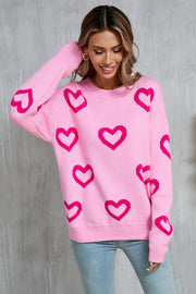 Fuchsia pink acrylic knit pullover sweater with allover heart intarsia pattern.