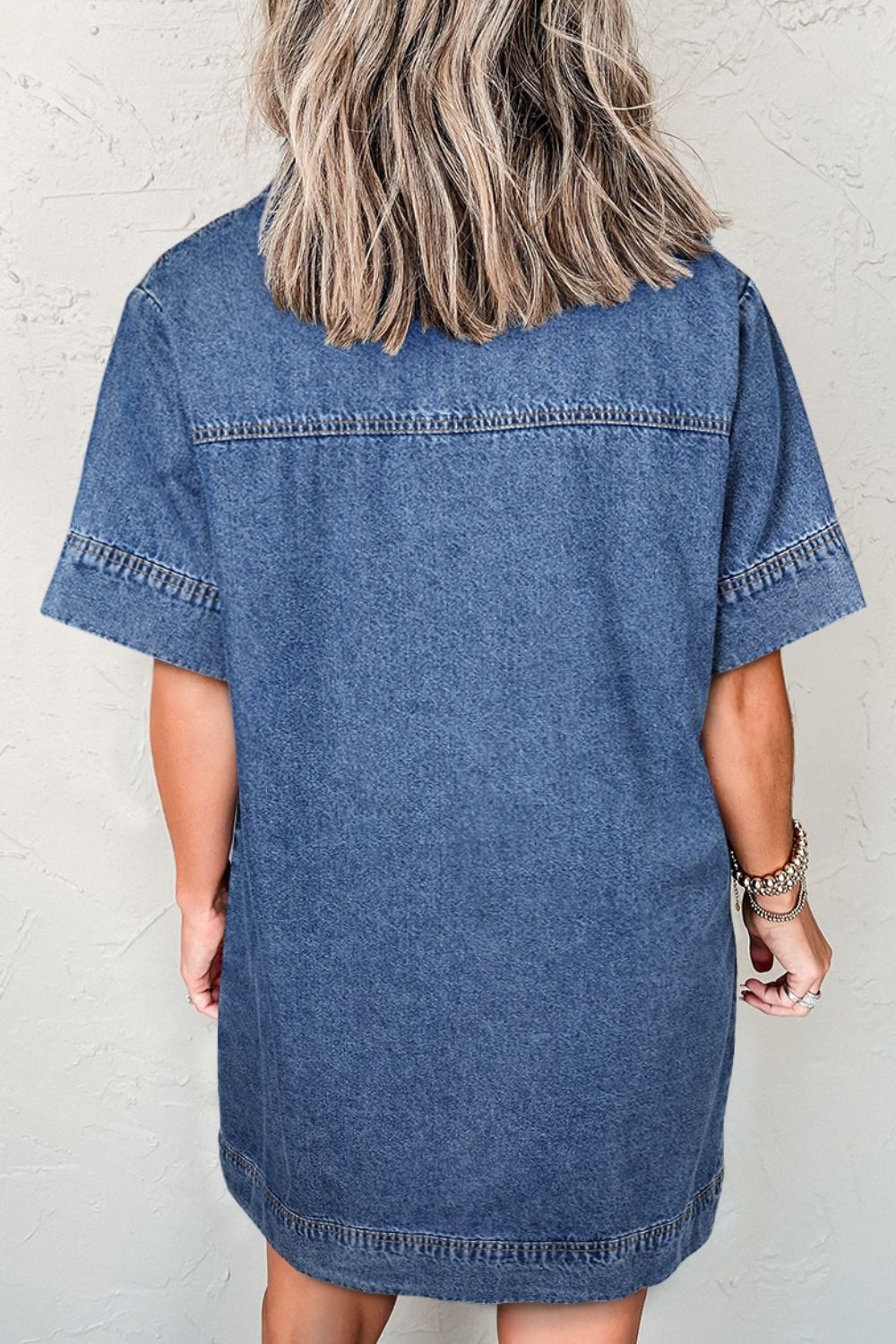 Light blue denim mini dress with short sleeves and a relaxed fit.