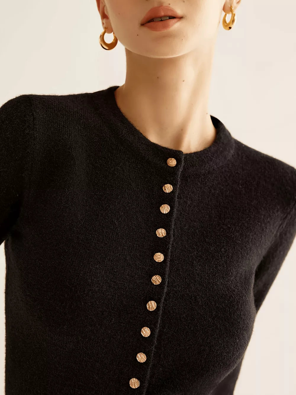 Black button-down slim cardigan with gold buttons and a crew neck.