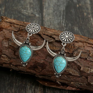 Southwestern crescent drop earrings with turquoise stones and silver bull horns.