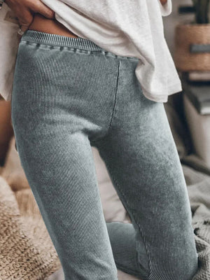 Dark gray ribbed leggings with a textured finish and elastic waistband.
