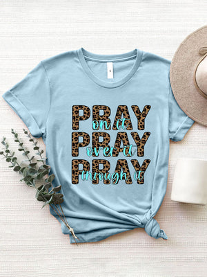 Light blue graphic tee with leopard print text saying Pray on it, Pray over it, Pray through it.