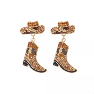 Cowboy hat and boot dangle earrings in brown with crystal embellishments.