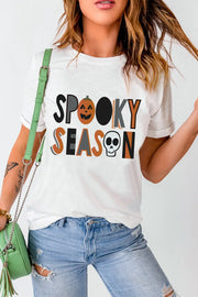 White t-shirt with "Spooky Season" graphic featuring a pumpkin and skull.