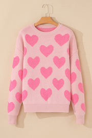 Blush pink knit sweater with allover textured heart motif and crewneck.