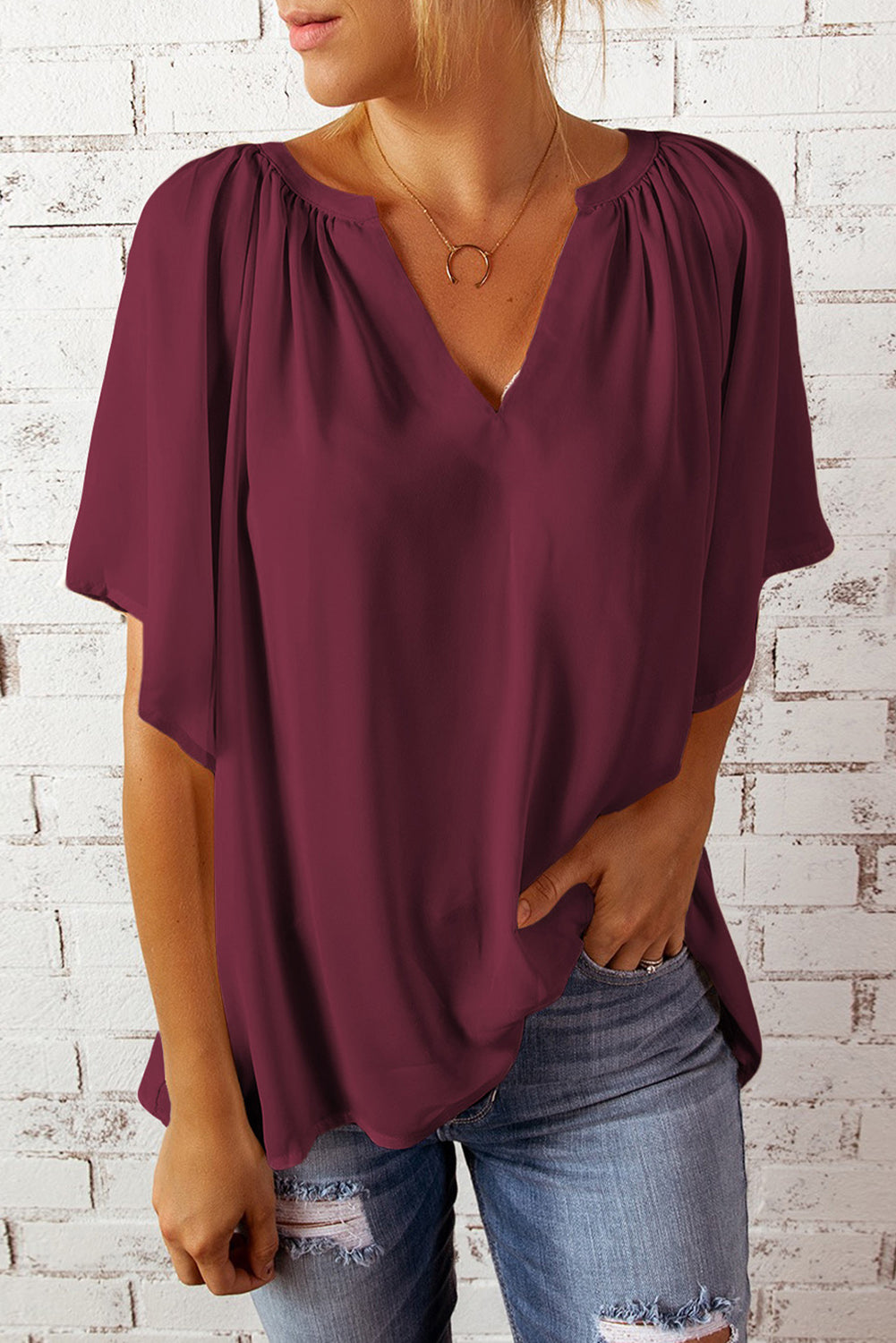 Wine relaxed V-neck blouse with cap sleeves and gathered neckline.