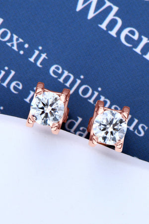 Rose gold moissanite solitaire stud earrings with clear round-cut stones.