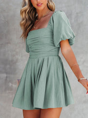 Sage ruched puff sleeve square neck romper with pleated skirt