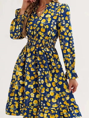 Blue floral dress with yellow blooms, smocked waist, ruffled cuffs and hem.
