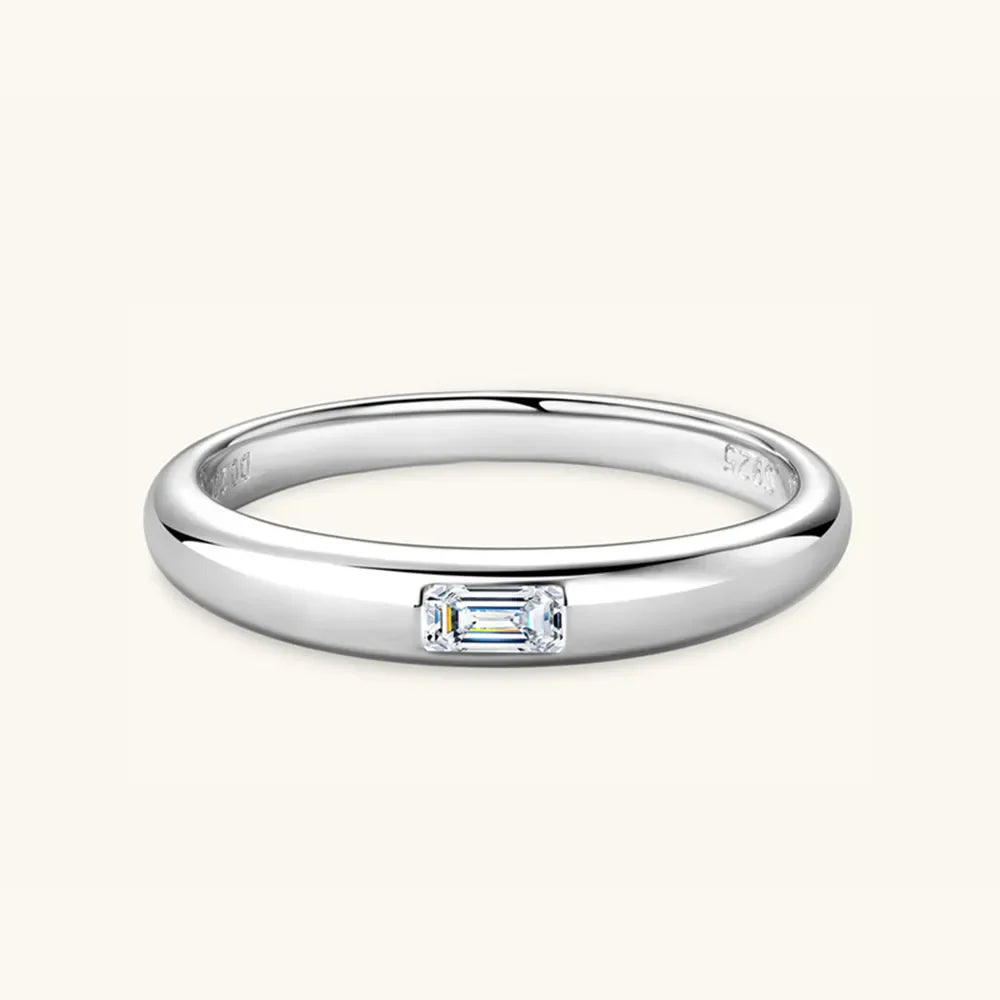 Silver band ring with a single rectangular moissanite gemstone.