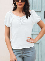 White ruched button-front puff sleeve blouse with textured fabric