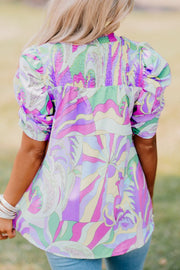 Multicolor smocked puff sleeve blouse with psychedelic print.