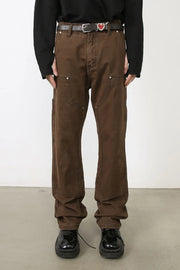 Coffee brown carpenter pants with utility pockets and metal rivets.
