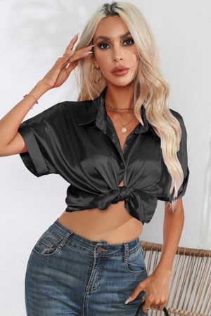 Black satin cuffed sleeve button-down blouse with a knotted front detail.
