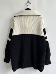 Black and white acrylic ribbed sweater with varsity stripes on collar and sleeves.