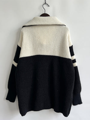Black and white acrylic ribbed sweater with varsity stripes on collar and sleeves.