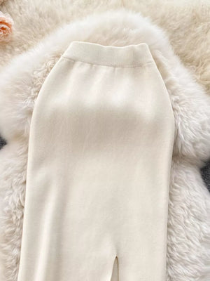 Off-white knit midi skirt with a side slit and ribbed waistband.