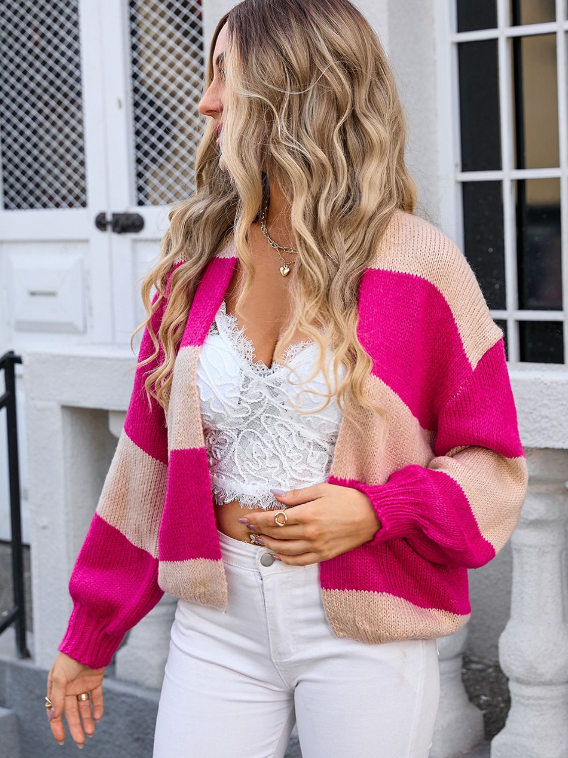 Colorblock balloon sleeve knit cardigan in pink and beige acrylic with a relaxed fit.