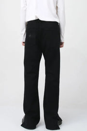 Flared hem denim trousers in dark cotton with a subtle distressed detail on the back pocket.