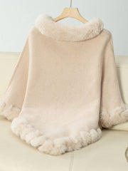 Beige knit poncho with faux fur trim at neckline and hem