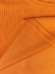 Orange ribbed knit crop top detail showing texture and seam.