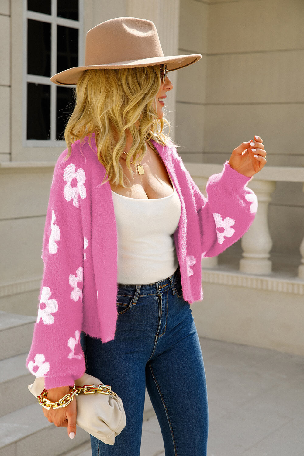 Fuchsia fuzzy cropped cardigan with white floral pattern, open front, long sleeves.