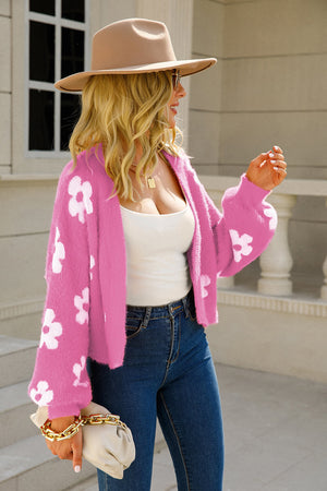 Fuchsia fuzzy cropped cardigan with white floral pattern, open front, long sleeves.