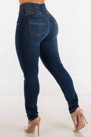 Dark wash skinny jeans with a sculpted elastic waistband and button fly, made of cotton.