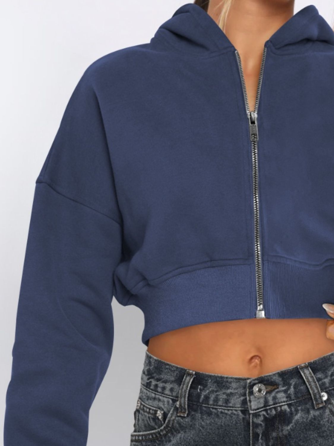 Navy cropped zip-up hoodie with ribbed hem and silver zipper detail.