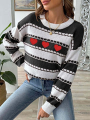 Black and white striped knit sweater with embroidered red hearts and a crew neck.