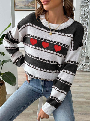 Black and white striped knit sweater with embroidered red hearts and a crew neck.