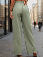 Sage linen blend drawstring palazzo trousers with vertical texture and side slits.